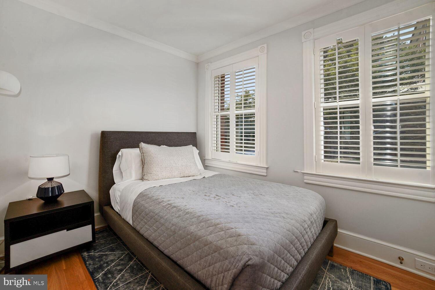 3348 Prospect Street Northwest, Unit 2 Washington, DC 20007 - Photo 5 of 11 a bedroom with a bed and wooden floor