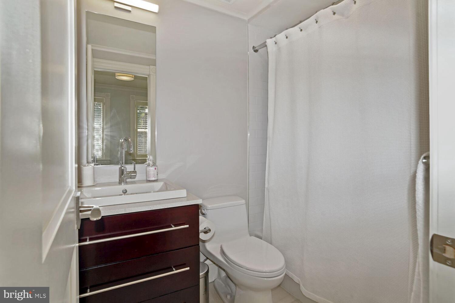 3348 Prospect Street Northwest, Unit 2 Washington, DC 20007 - Photo 7 of 11 a bathroom with a sink a toilet and shower