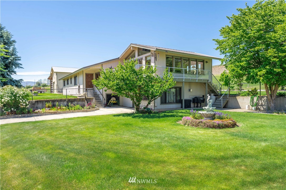 485 Stayman Flats Road Chelan, WA 98816 - Photo 1 of 32 a front view of a house with a yard and porch