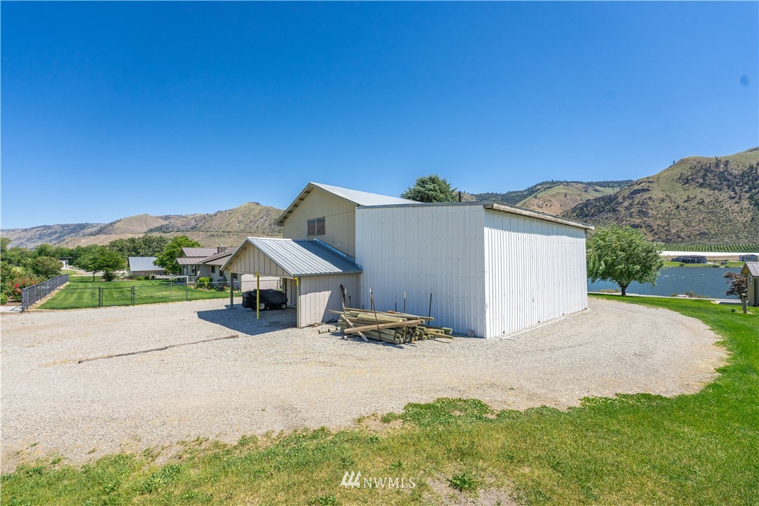 485 Stayman Flats Road Chelan, WA 98816 - Photo 16 of 32 a view of a house with a yard