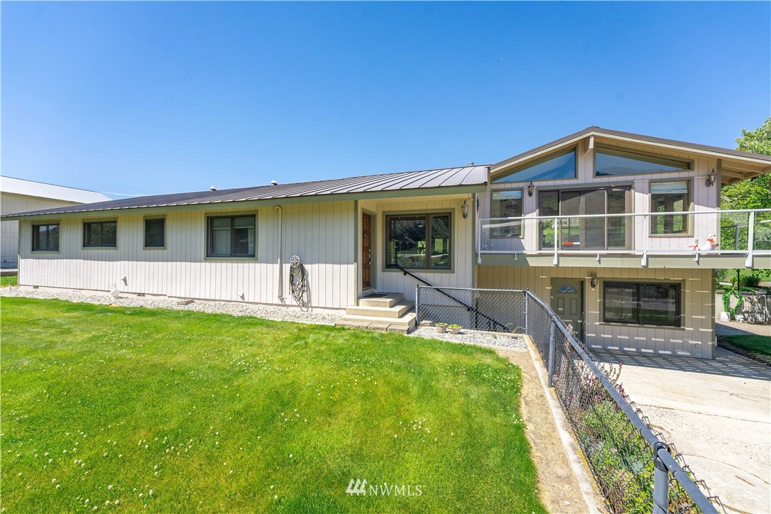 485 Stayman Flats Road Chelan, WA 98816 - Photo 21 of 32 a view of a house with a yard patio and a yard