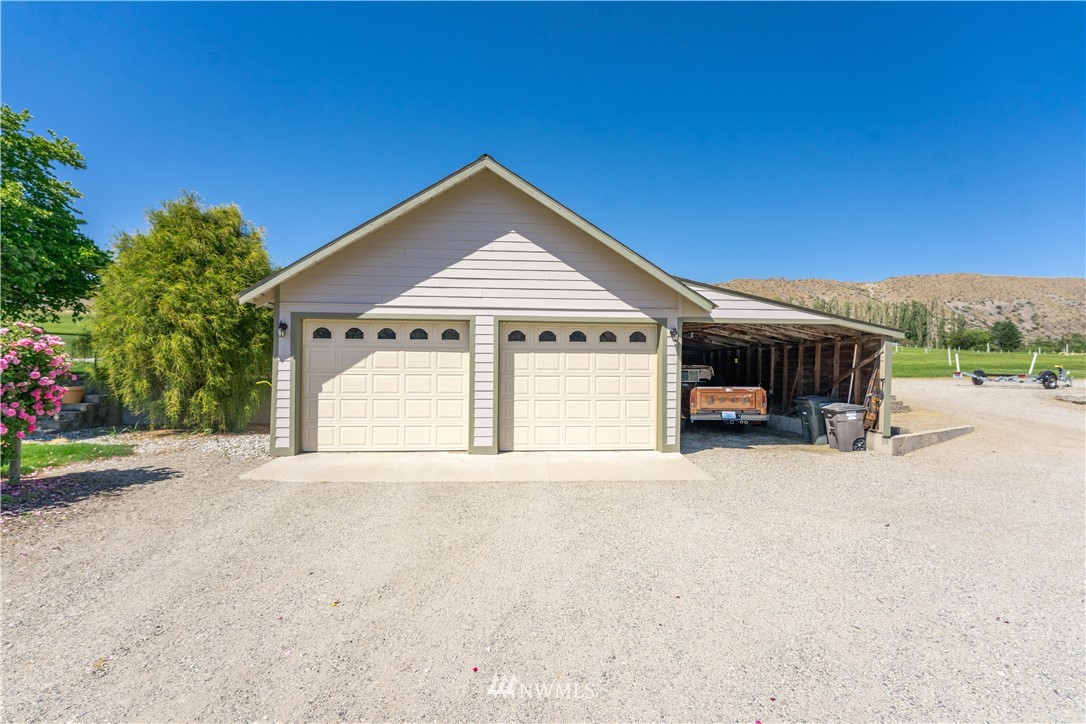 485 Stayman Flats Road Chelan, WA 98816 - Photo 23 of 32 a front view of a house with a yard and garage