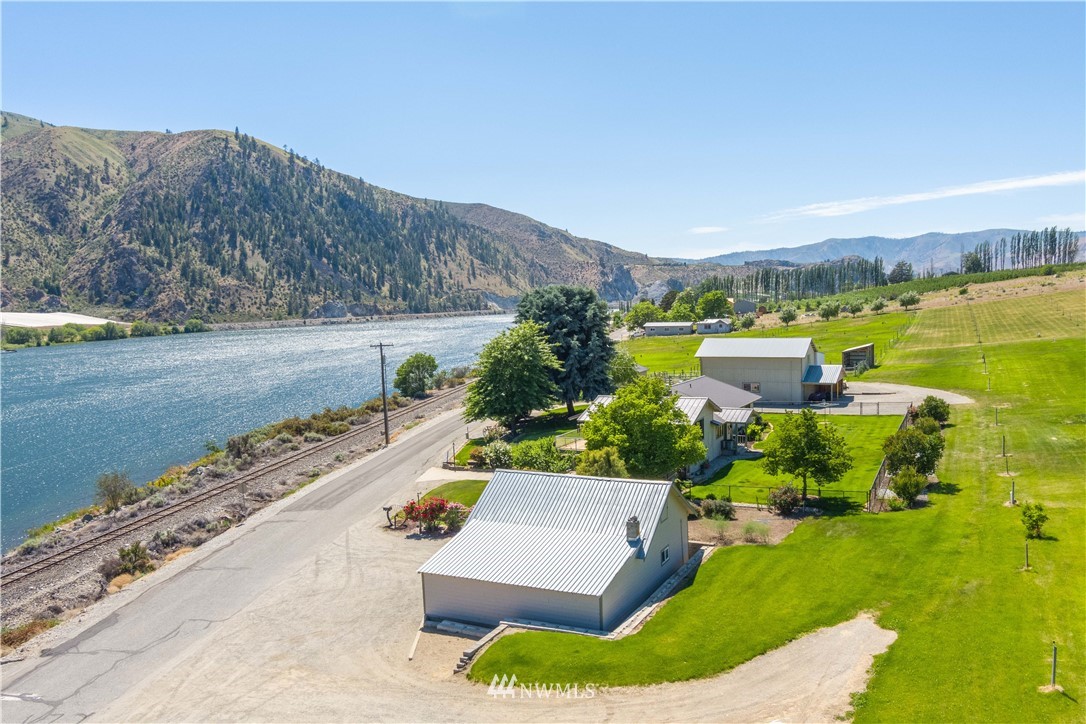 485 Stayman Flats Road Chelan, WA 98816 - Photo 32 of 32 an aerial view of a house with outdoor space swimming pool and mountains
