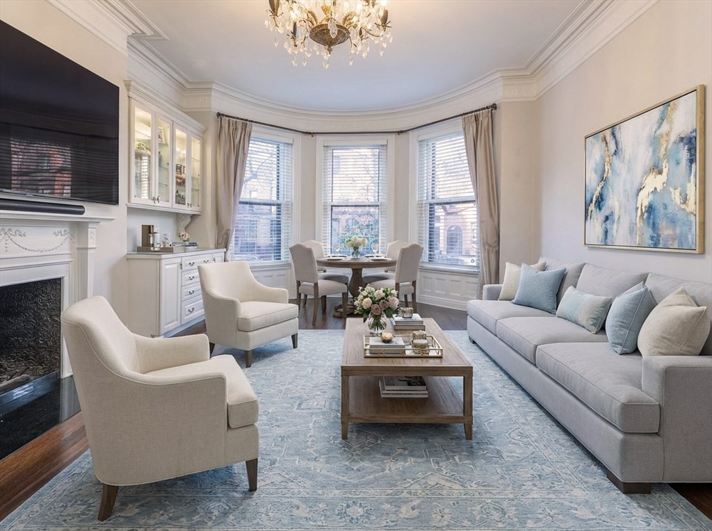 461 Beacon Street, Unit 1 Boston, MA 02115 - Photo 1 of 8 a living room with furniture fireplace and a large window