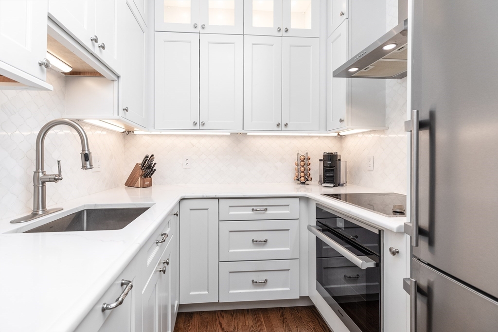 461 Beacon Street, Unit 1 Boston, MA 02115 - Photo 3 of 8 a kitchen with cabinets stainless steel appliances and a counter space