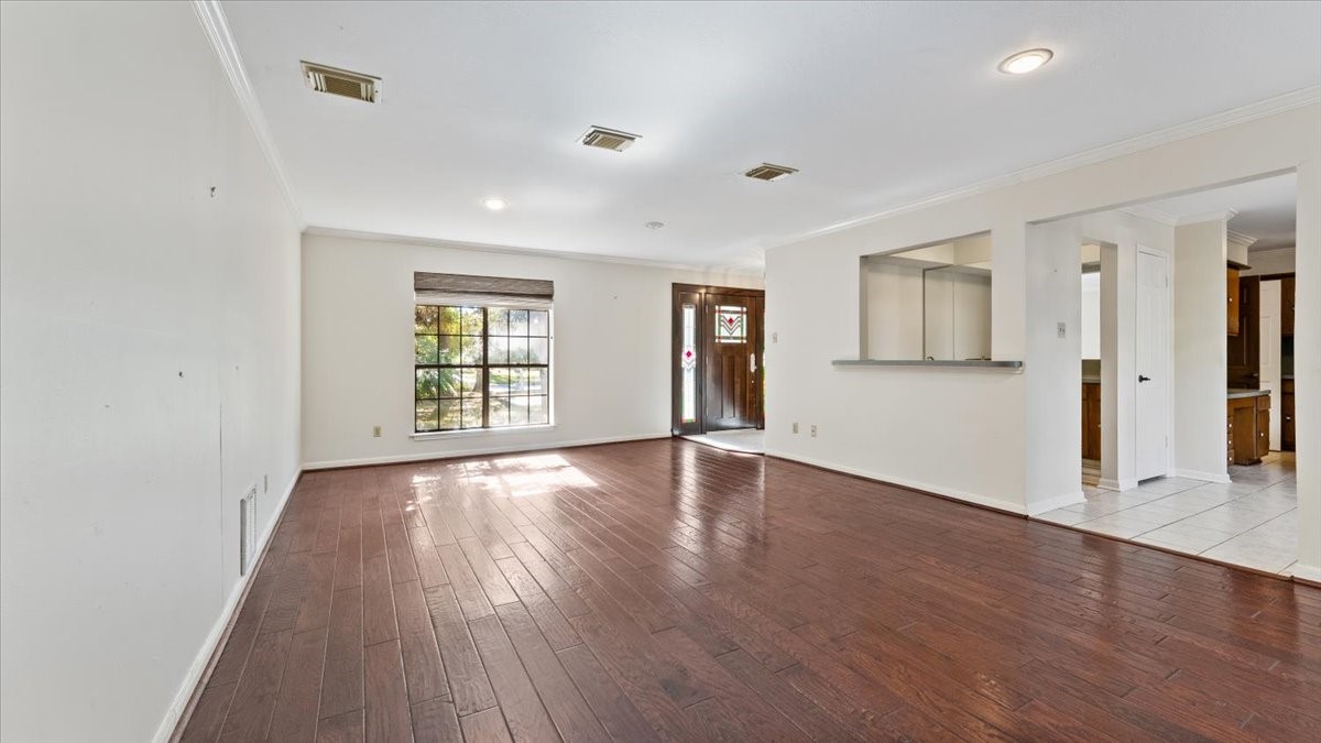 6502 Moccasin Bend Drive Spring, TX 77379 - Photo 12 of 38 a view of an empty room with wooden floor and a window