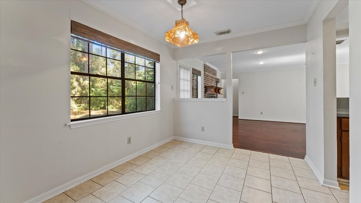 6502 Moccasin Bend Drive Spring, TX 77379 - Photo 13 of 38 en empty room with windows and chandelier