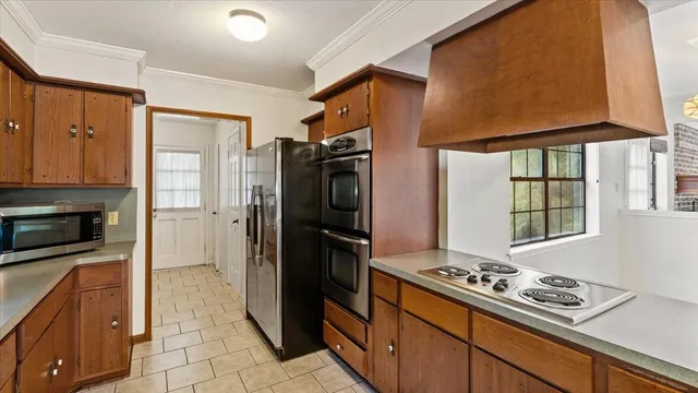 a kitchen with stainless steel appliances granite countertop a refrigerator stove and sink