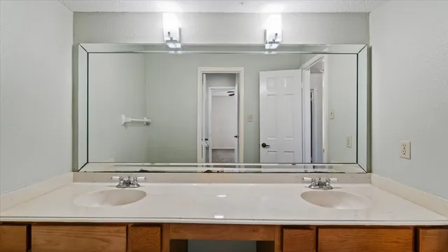 a bathroom with a sink and mirror