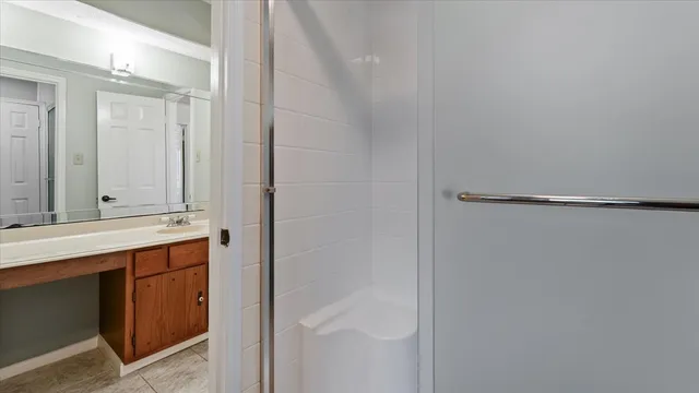 an empty room with a ceiling fan and bathroom