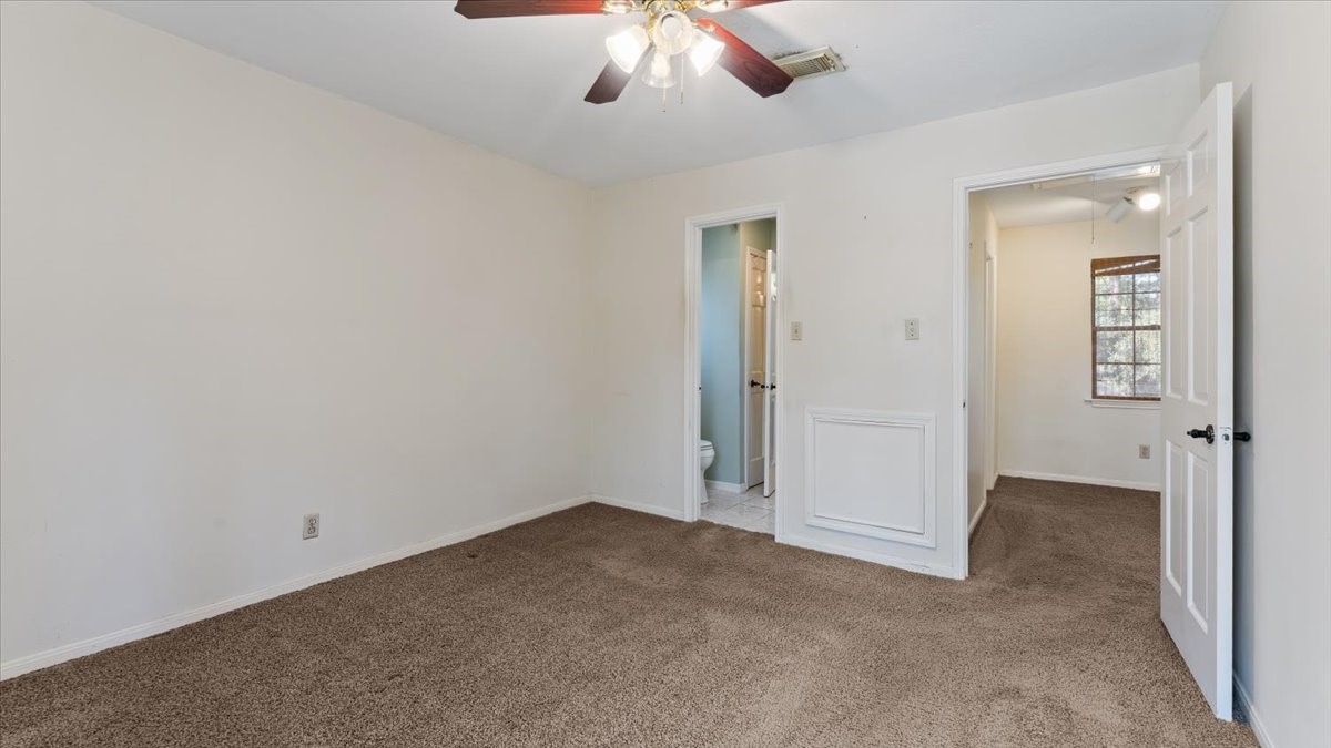 6502 Moccasin Bend Drive Spring, TX 77379 - Photo 26 of 38 an empty room with a ceiling fan and bathroom