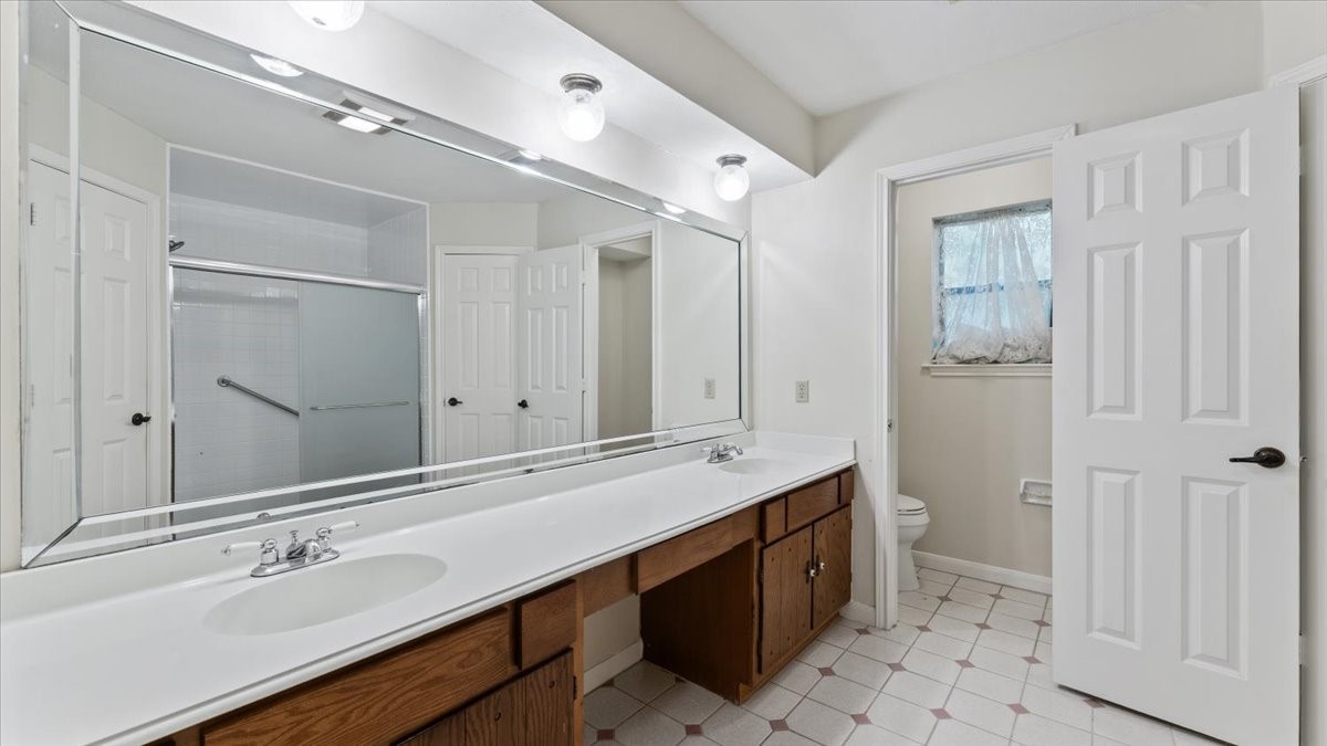 6502 Moccasin Bend Drive Spring, TX 77379 - Photo 30 of 38 a bathroom with a double vanity sink a mirror and a shower