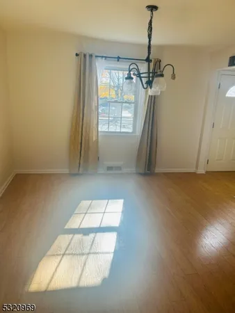 a view of an empty room with a fireplace