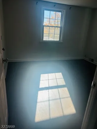 a view of a room with wooden floor and brick walls