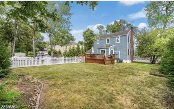 a house with huge green field in front of it