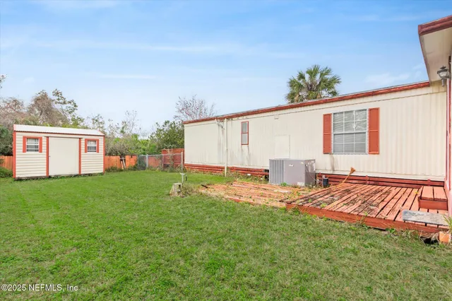 a backyard of a house with table and chairs