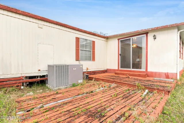 a view of backyard with deck and garden