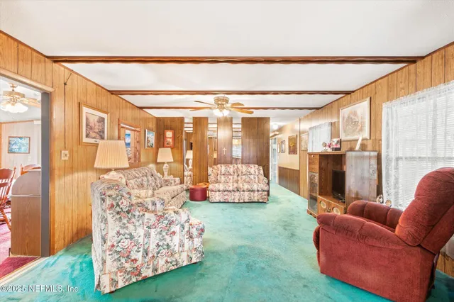 a living room with furniture and a floor to ceiling window