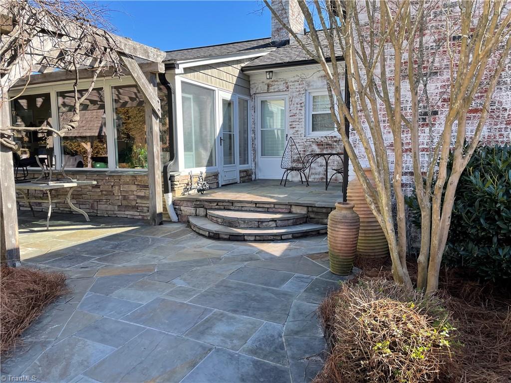 2532 Darrow Road Walkertown, NC 27051 - Photo 34 of 38 Small patio accessed from 30 x 10 sunroom as well as multi-use room: office/3rd bedroom/laundry area