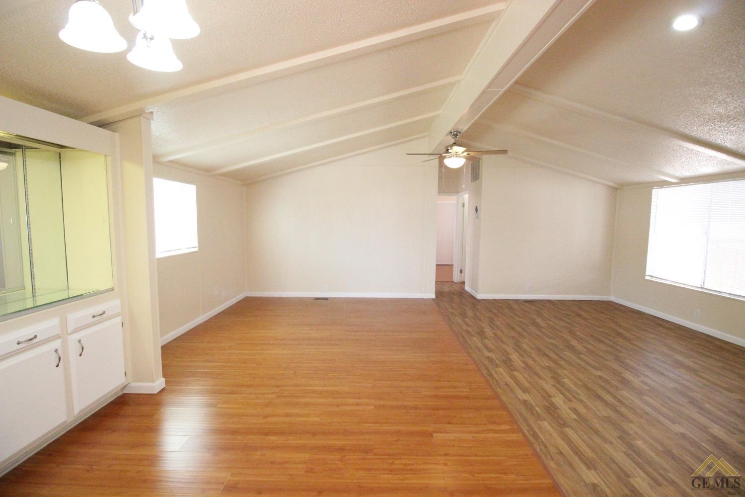 Undisclosed Address Bakersfield, CA 93308 - Photo 13 of 26 a view of empty room with wooden floor and fan