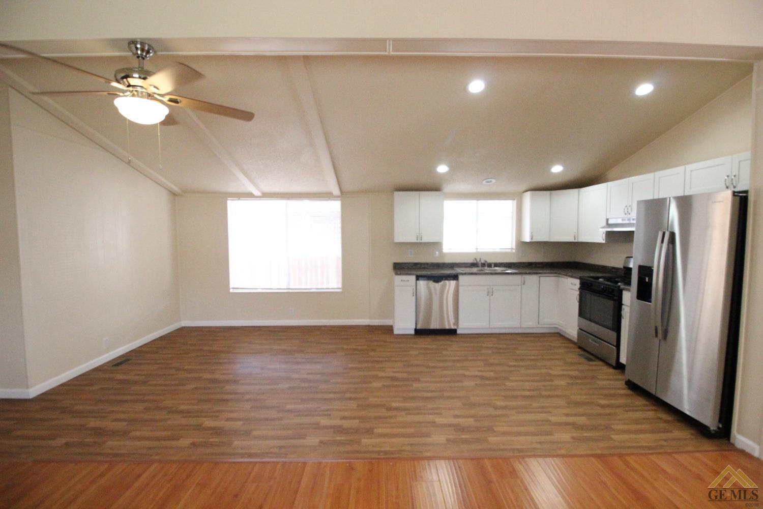 Undisclosed Address Bakersfield, CA 93308 - Photo 14 of 26 a view of kitchen with wooden floor electronic appliances and window