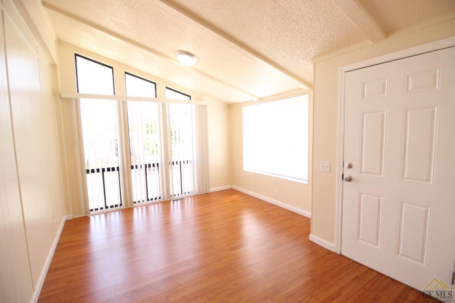 Undisclosed Address Bakersfield, CA 93308 - Photo 15 of 26 a view of an empty room with wooden floor and a window