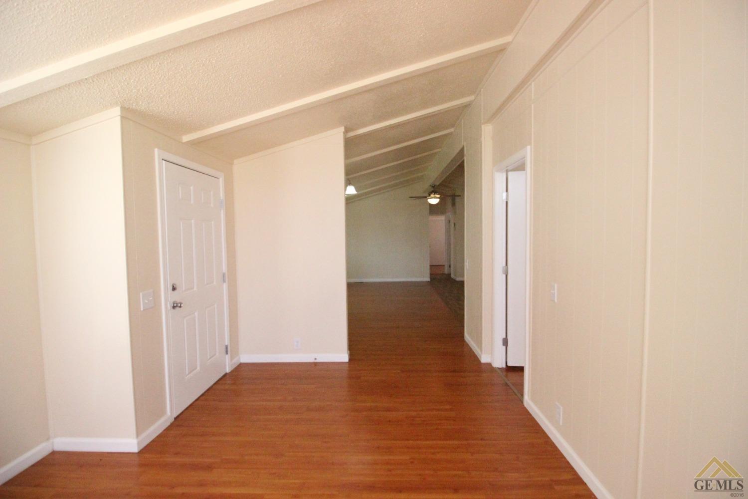 Undisclosed Address Bakersfield, CA 93308 - Photo 16 of 26 a view of a hallway with wooden floor