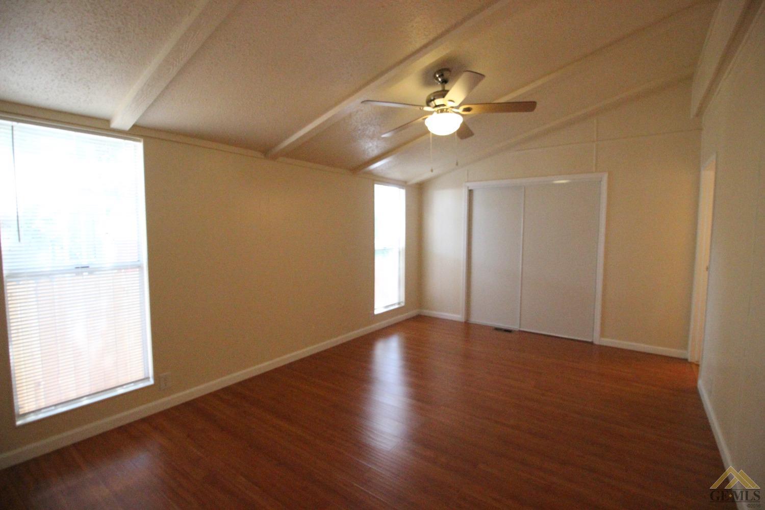 Undisclosed Address Bakersfield, CA 93308 - Photo 20 of 26 a view of an empty room with wooden floor and a window