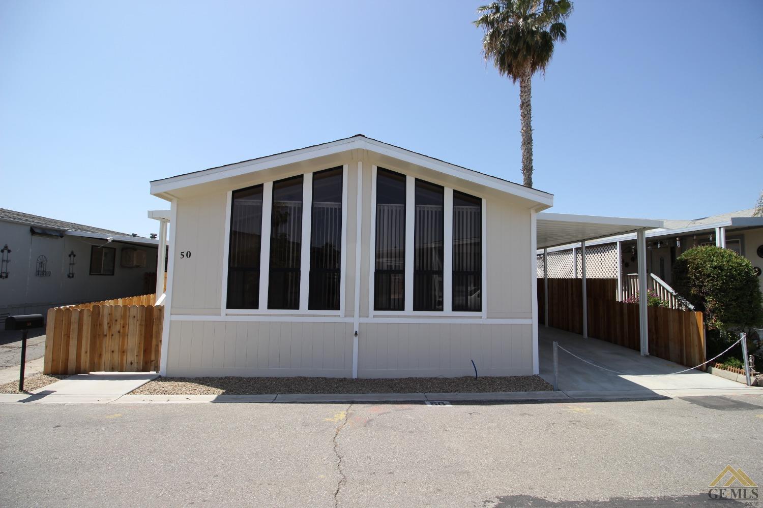 Undisclosed Address Bakersfield, CA 93308 - Photo 2 of 26 a view of a house with a window and wooden fence