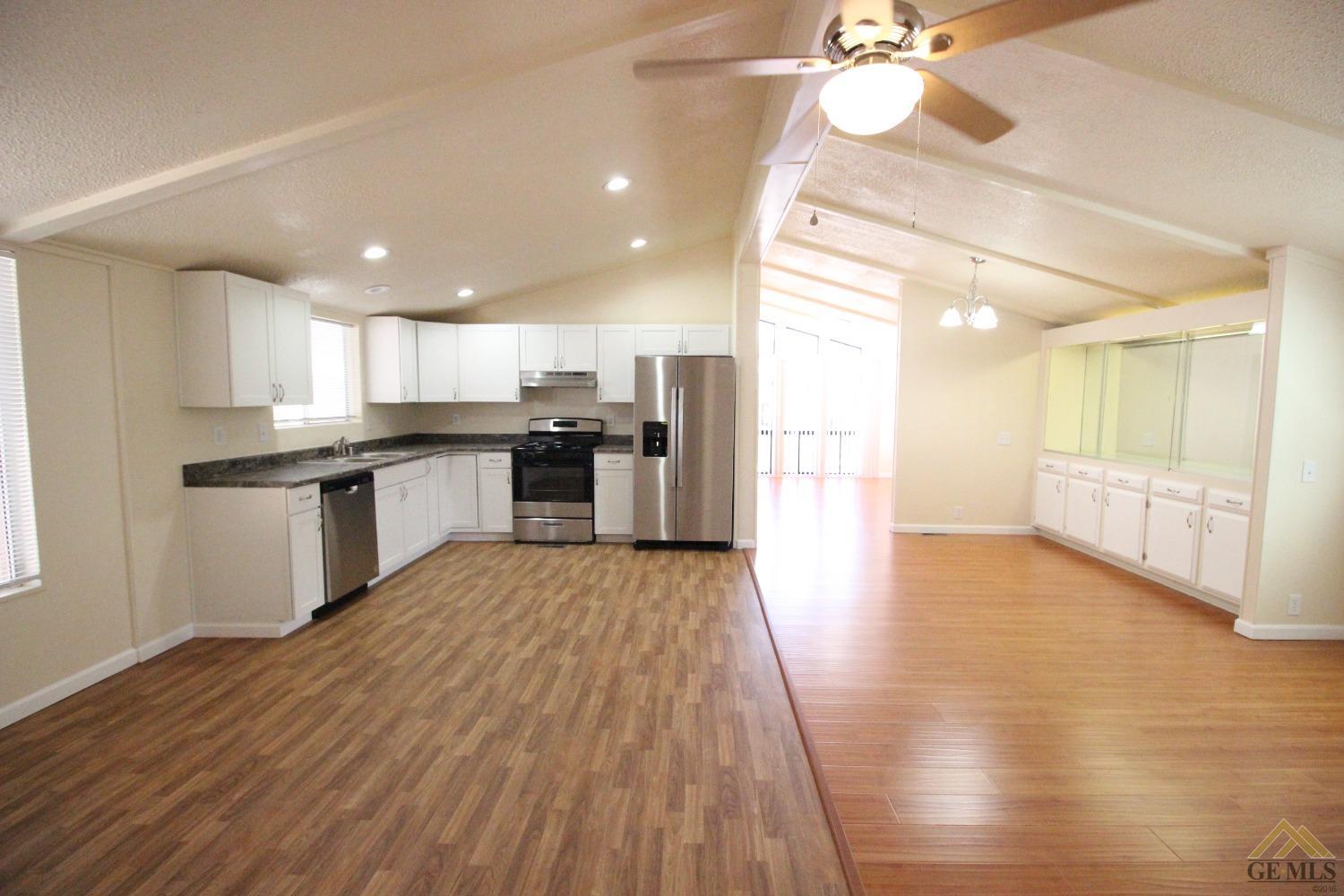 Undisclosed Address Bakersfield, CA 93308 - Photo 8 of 26 a view of kitchen with cabinets and wooden floor