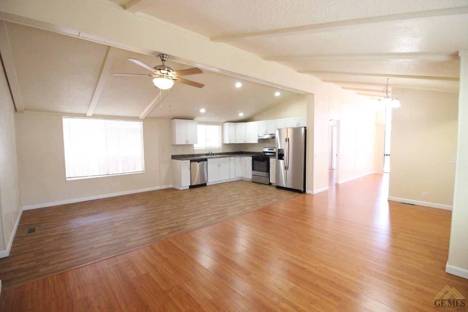 Undisclosed Address Bakersfield, CA 93308 - Photo 9 of 26 a view of a kitchen with a stove cabinets and wooden floor
