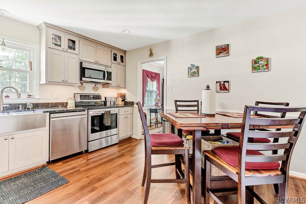 11431 Driscoll Road Chester, VA 23831 - Photo 11 of 41 a kitchen with stainless steel appliances a white table and chairs in it
