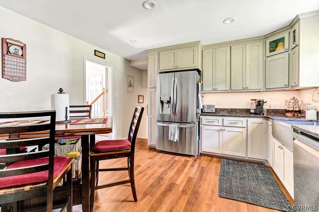 11431 Driscoll Road Chester, VA 23831 - Photo 12 of 41 a kitchen with stainless steel appliances a refrigerator a stove a sink and white cabinets with wooden floor