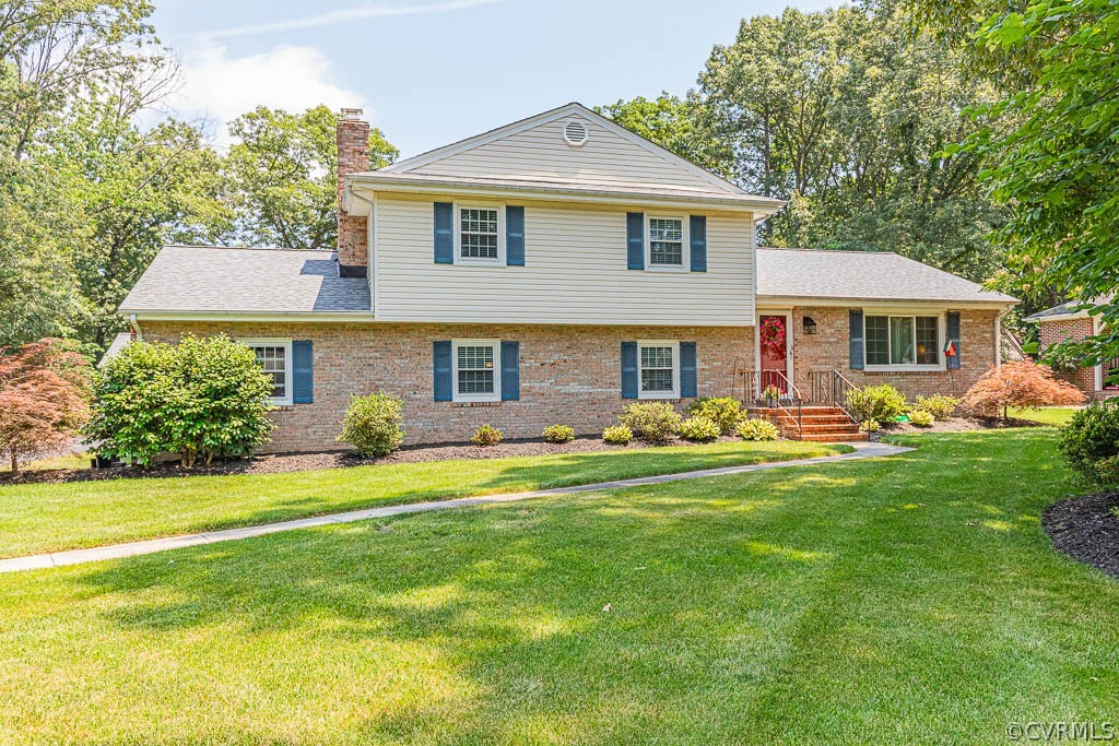 11431 Driscoll Road Chester, VA 23831 - Photo 2 of 41 a front view of a house with a garden and trees