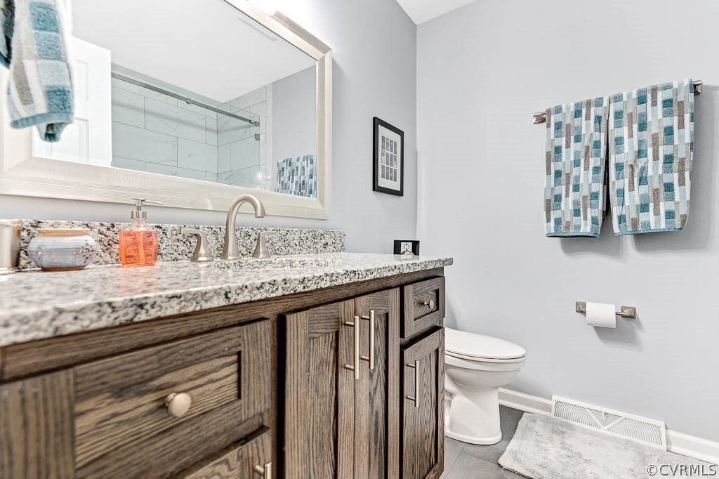 11431 Driscoll Road Chester, VA 23831 - Photo 22 of 41 a bathroom with a granite countertop toilet sink and mirror