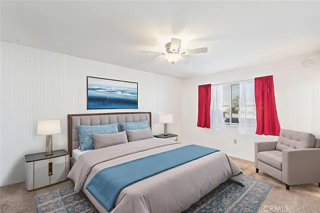 an empty room with a window and a ceiling fan