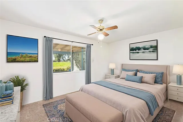 an empty room with a window and a ceiling fan