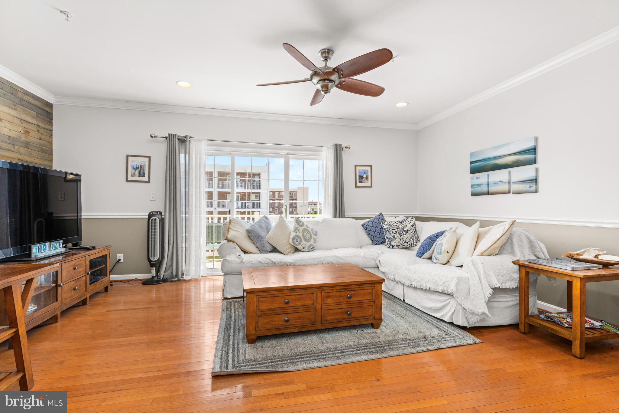 617 Salt Spray Road, Unit B Ocean City, MD 21842 - Photo 43 of 72 a living room with furniture and a flat screen tv with wooden floor