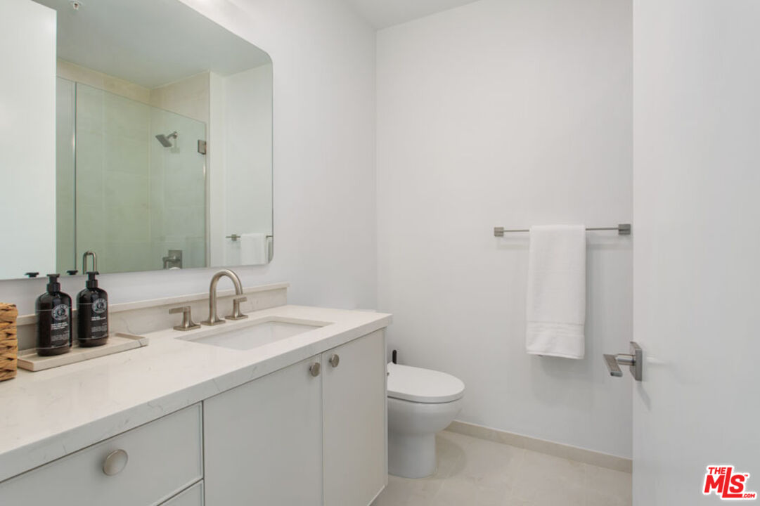 10310 Santa Monica Boulevard, Unit 216 Los Angeles, CA 90025 - Photo 11 of 38 a bathroom with a sink toilet and shower