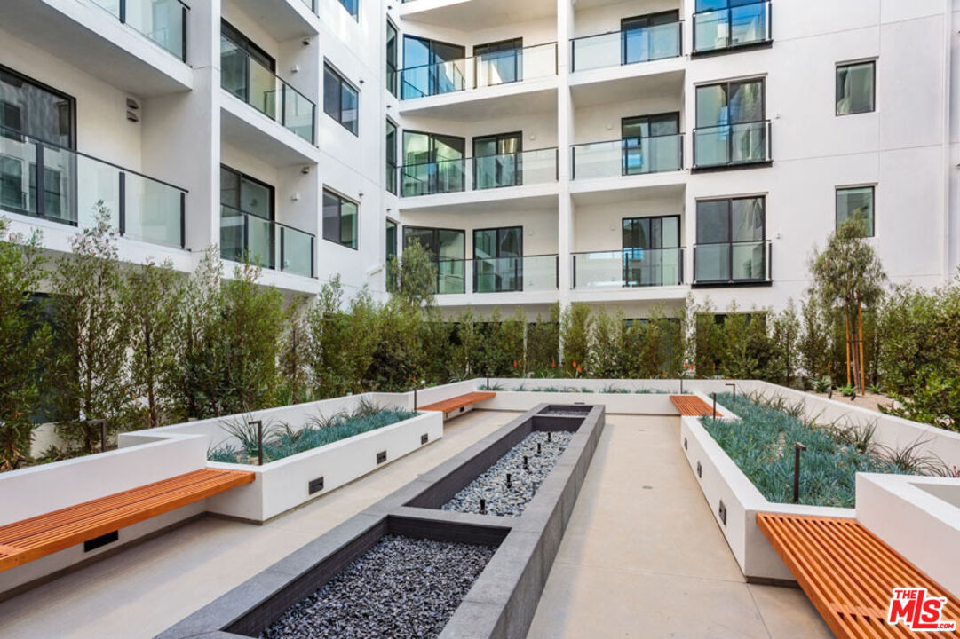 10310 Santa Monica Boulevard, Unit 216 Los Angeles, CA 90025 - Photo 32 of 38 a buildings view with sitting space and garden view