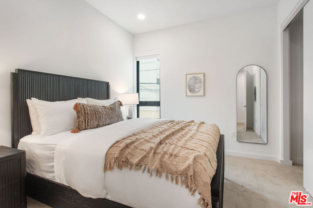 10310 Santa Monica Boulevard, Unit 216 Los Angeles, CA 90025 - Photo 10 of 38 a bedroom with bed and window