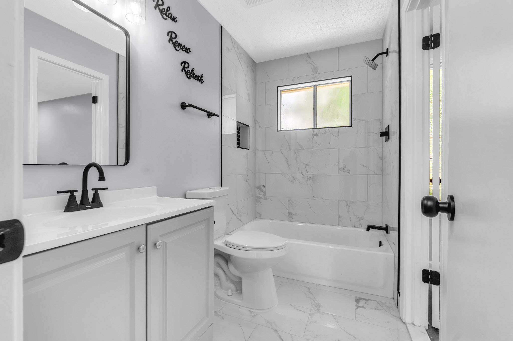 3314 Bright Ridge Cove Memphis, TN 38115 - Photo 11 of 16 Bathroom featuring a single vanity with light gray cabinetry, a white countertop, and a black faucet