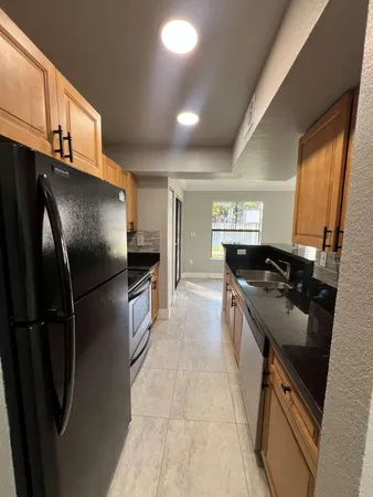 a kitchen with a refrigerator and a sink