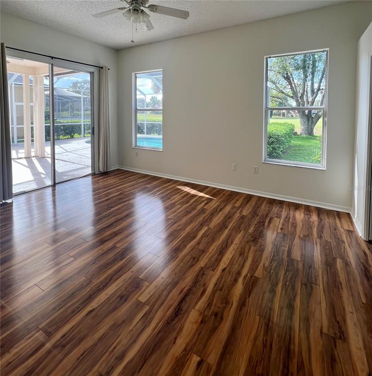 3515 Fox Squirrel Lane Valrico, FL 33596 - Photo 11 of 24 an empty room with wooden floor and windows