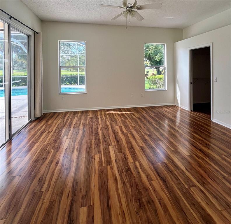 3515 Fox Squirrel Lane Valrico, FL 33596 - Photo 12 of 24 wooden floor in an empty room with a window