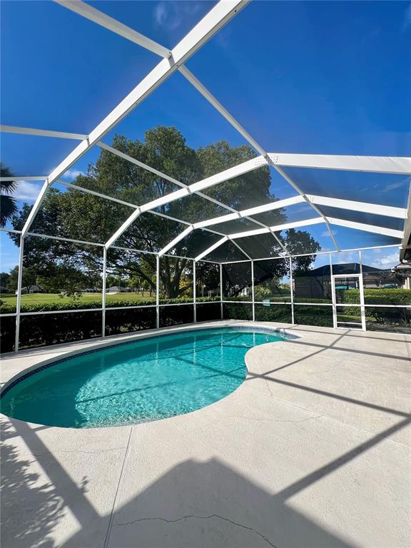 3515 Fox Squirrel Lane Valrico, FL 33596 - Photo 21 of 24 a view of a backyard with table and chairs under an umbrella