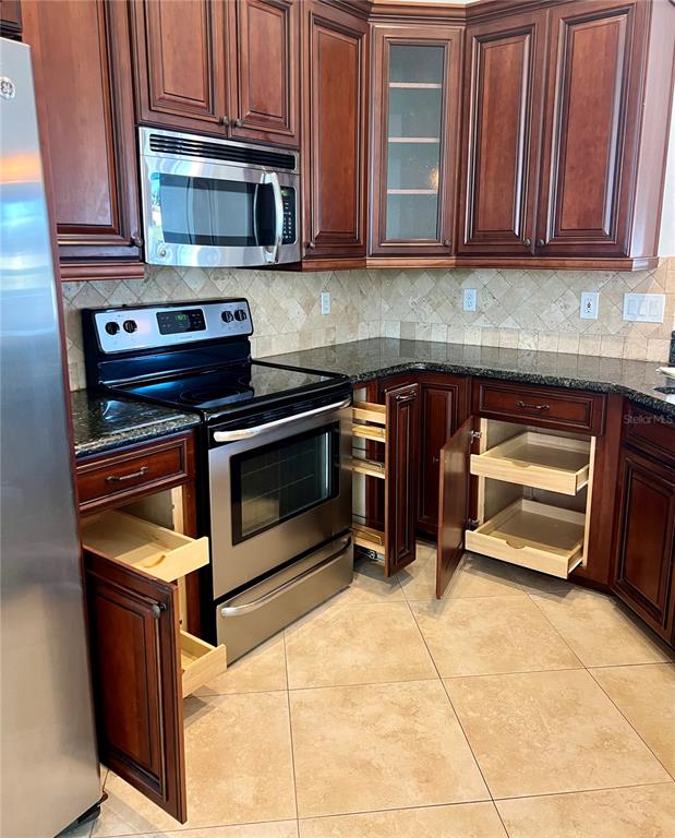 3515 Fox Squirrel Lane Valrico, FL 33596 - Photo 8 of 24 a kitchen with a stove and a microwave