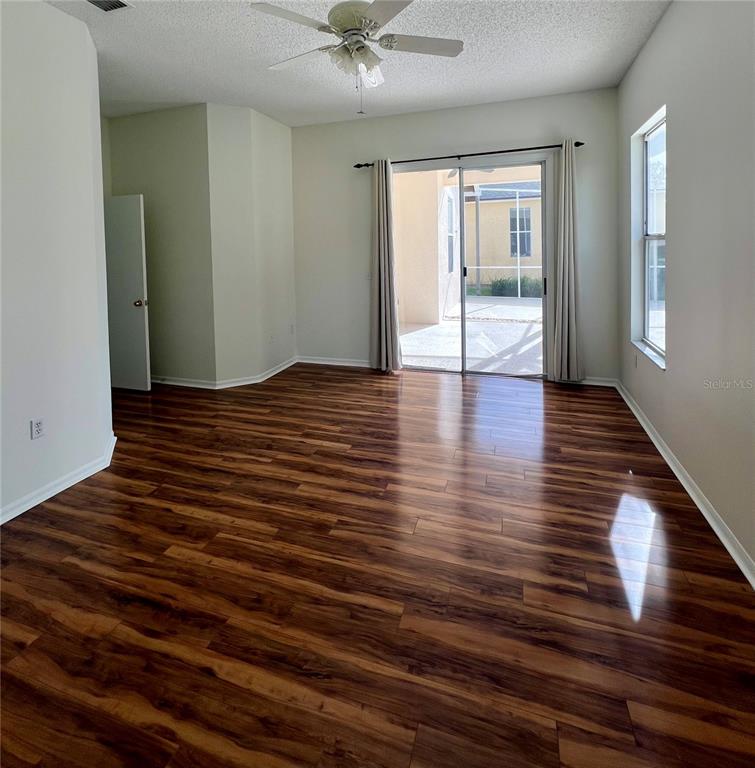 3515 Fox Squirrel Lane Valrico, FL 33596 - Photo 10 of 24 a view of an empty room with wooden floor and a window