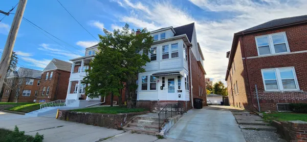 a view of a brick building next to a yard