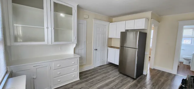 a kitchen with a refrigerator and a cabinets